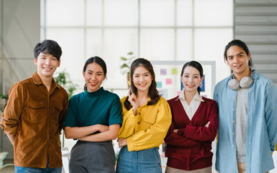 Group of Asia young creative people in smart casual wear smiling